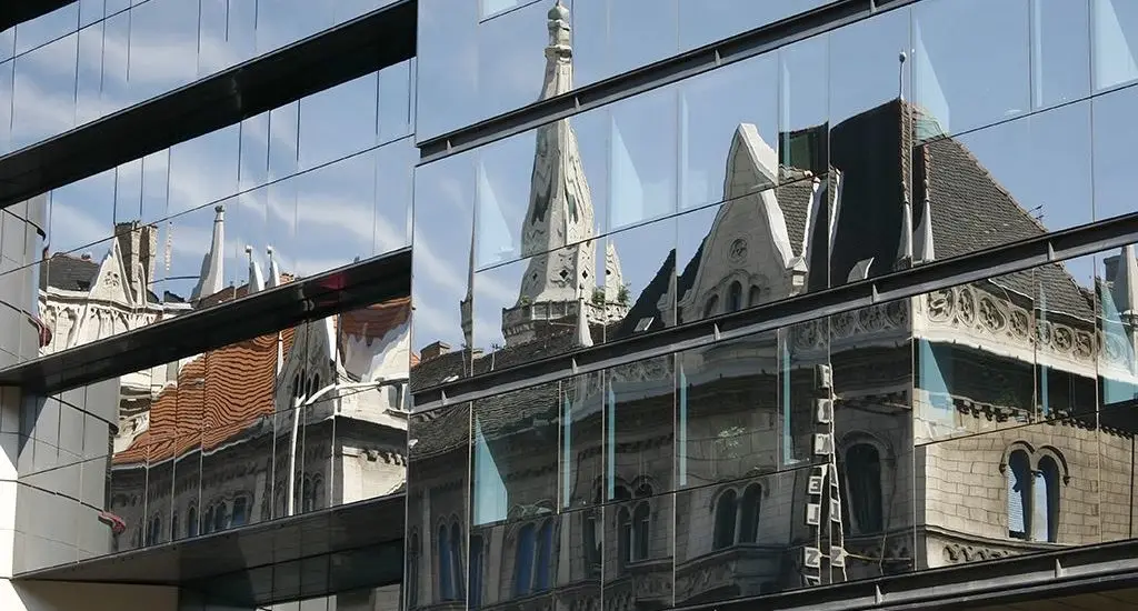old building reflected in office windows